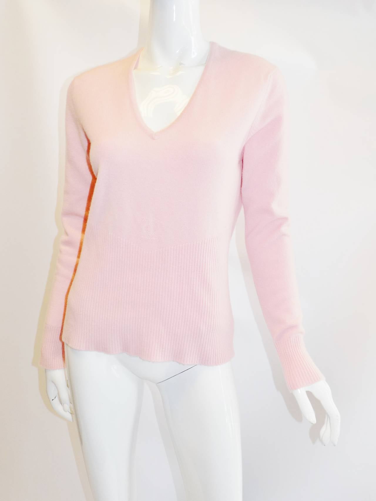 Perfect for any season . Lite pink 100%R cashmere Chanel pullover sweater. Featuring V neckline, ribbed sleeve cuffs  and part of the torso with cc logo at the front. Excellent condition. Coll. spring 2005. size 42