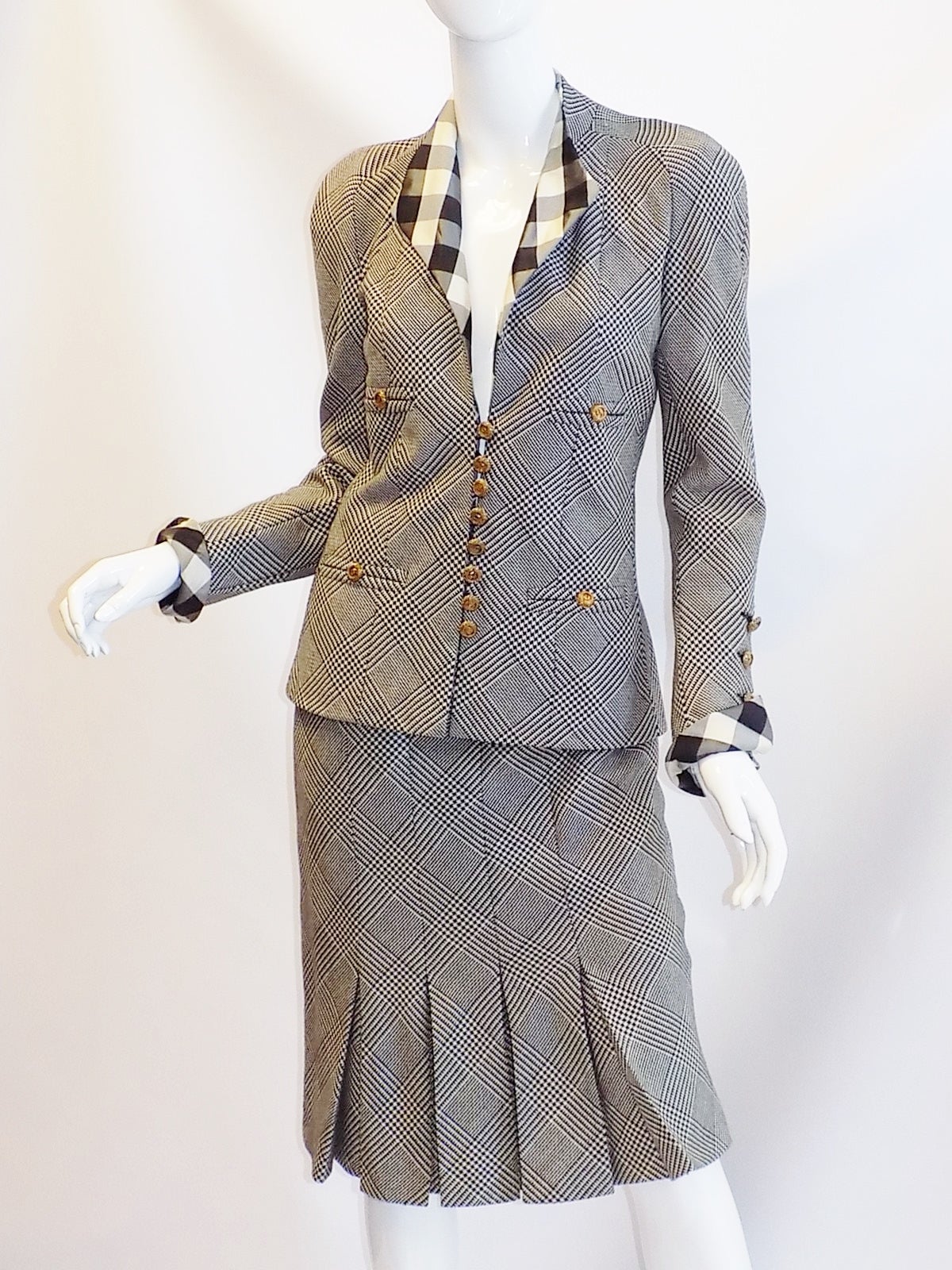 Lite wool  hounds-tooth gabardine in black and white plaid . Silk taffeta check detail accents . Spectacular gold tone metal  cc logo  buttons . Skirt is kick pleat back and front. Side zipper.. ID number # 63278
Silk lined with gold metal
