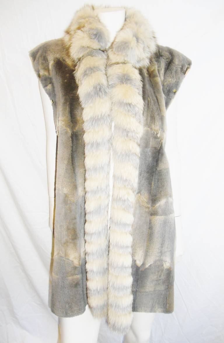 Grunstein couture  from Finland fabulous  fur coat. Removable sleeves give this coat  so many different looks. . Harlequin ( diamond shaped ) cotton  print fabric is water proof. Sleeves are attached with snaps on leather strip. Longer V shape back