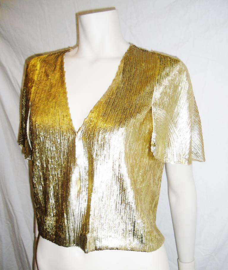 A must have stunning Christian Dior Fish-scale  sequens  Cropped bolero style jacket/ top. Flapper sleeves. Hook and eye front closure, silk lining.  Timeless item to be worn aw a evening peace or with jeans. Never worn .
Size 4
Bust 40