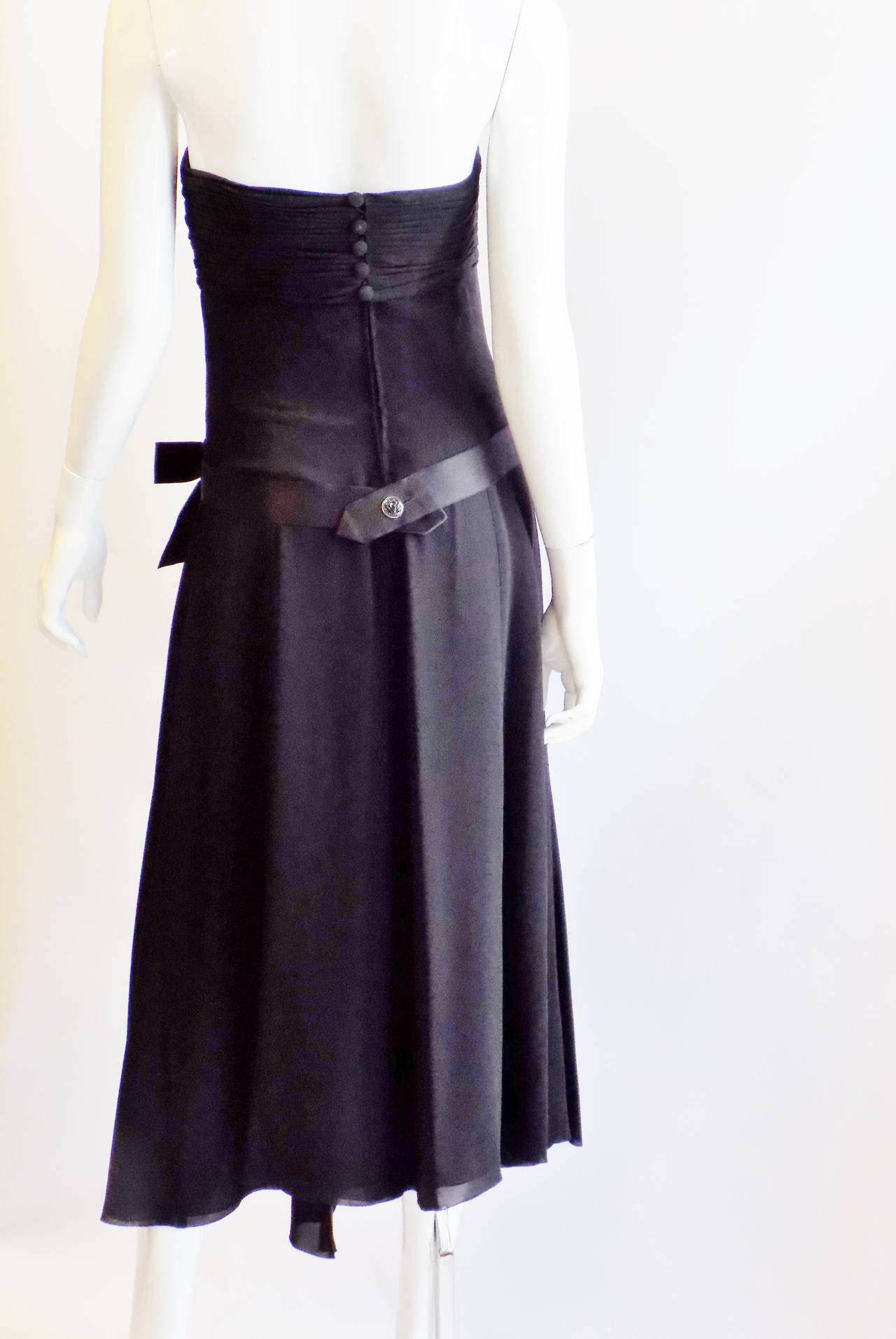 This piece is a must have in your closet. It will never go out of style and no matter when your occasion is Spring, summer, winter or fall you can always slip this dress on and look spectacular!! 
Black silk chiffon with corset rushed bodice  .