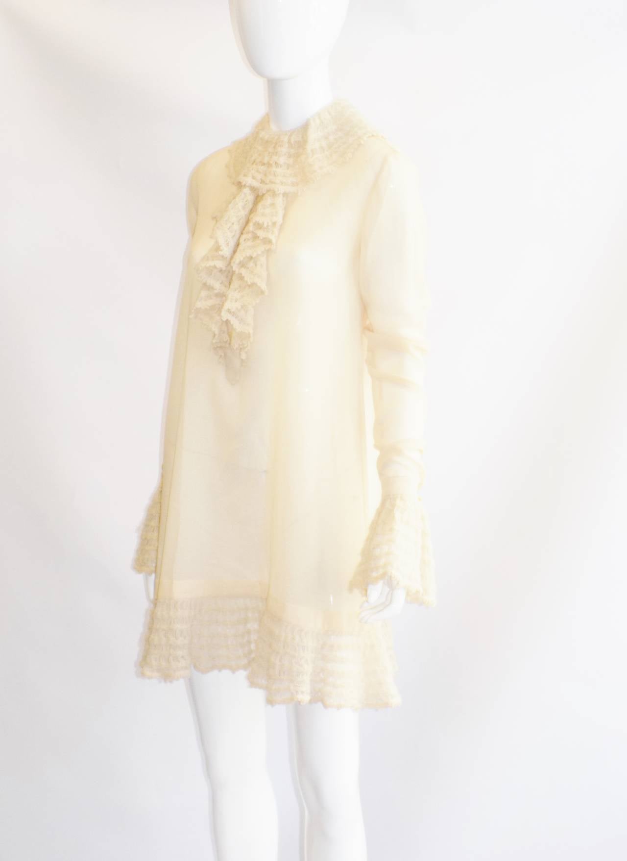 Spectacular lite wool ivory dress by Martine Sitbone for Chloe.  The girly touch of the hand crochet collar and cuffs  emphasizes the romanticism .  power dressing has been replaced by a doll-like trapeze  style. Back concealed button down closure