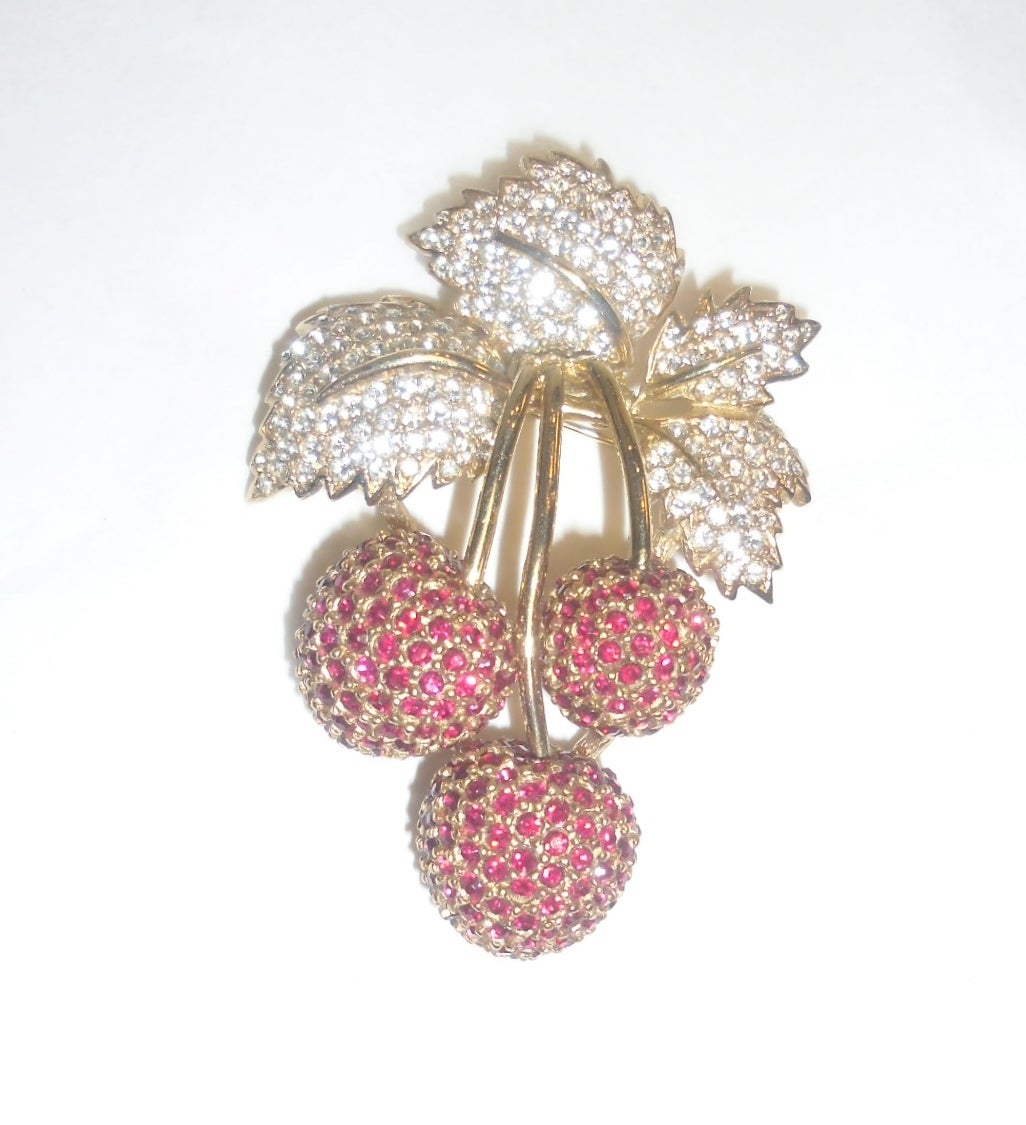 Exquisite, mid-century, vintage brooch in the form of three black cherries with crystal  encrusted leaves and ruby red crystal cherries . The brooch measures 3