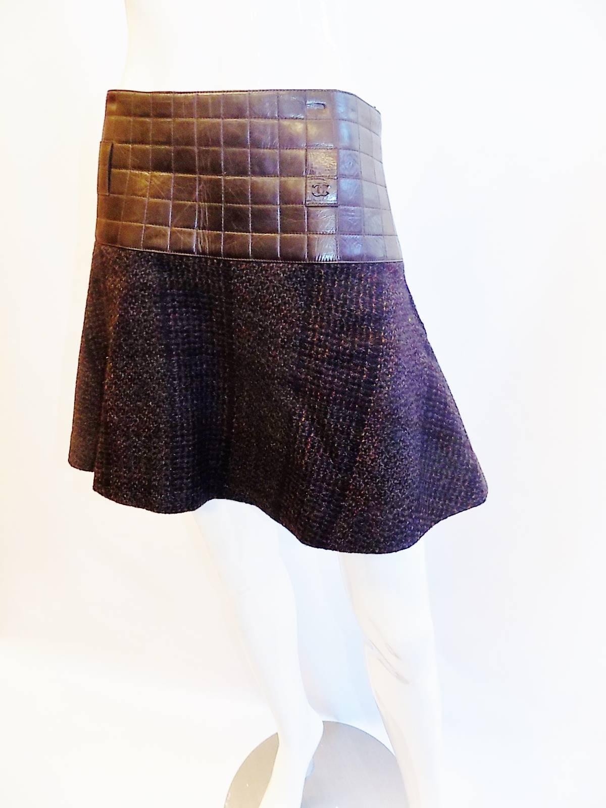 Must Have for winter with boots! dark distressed quilted leather with flare skater look wool buckle.  Belt loops concealed at the low hip area. Absolutely adorable skirt!!   Pristine condition. Like new. Collection Fall 2002 
size 38 low waist 32
