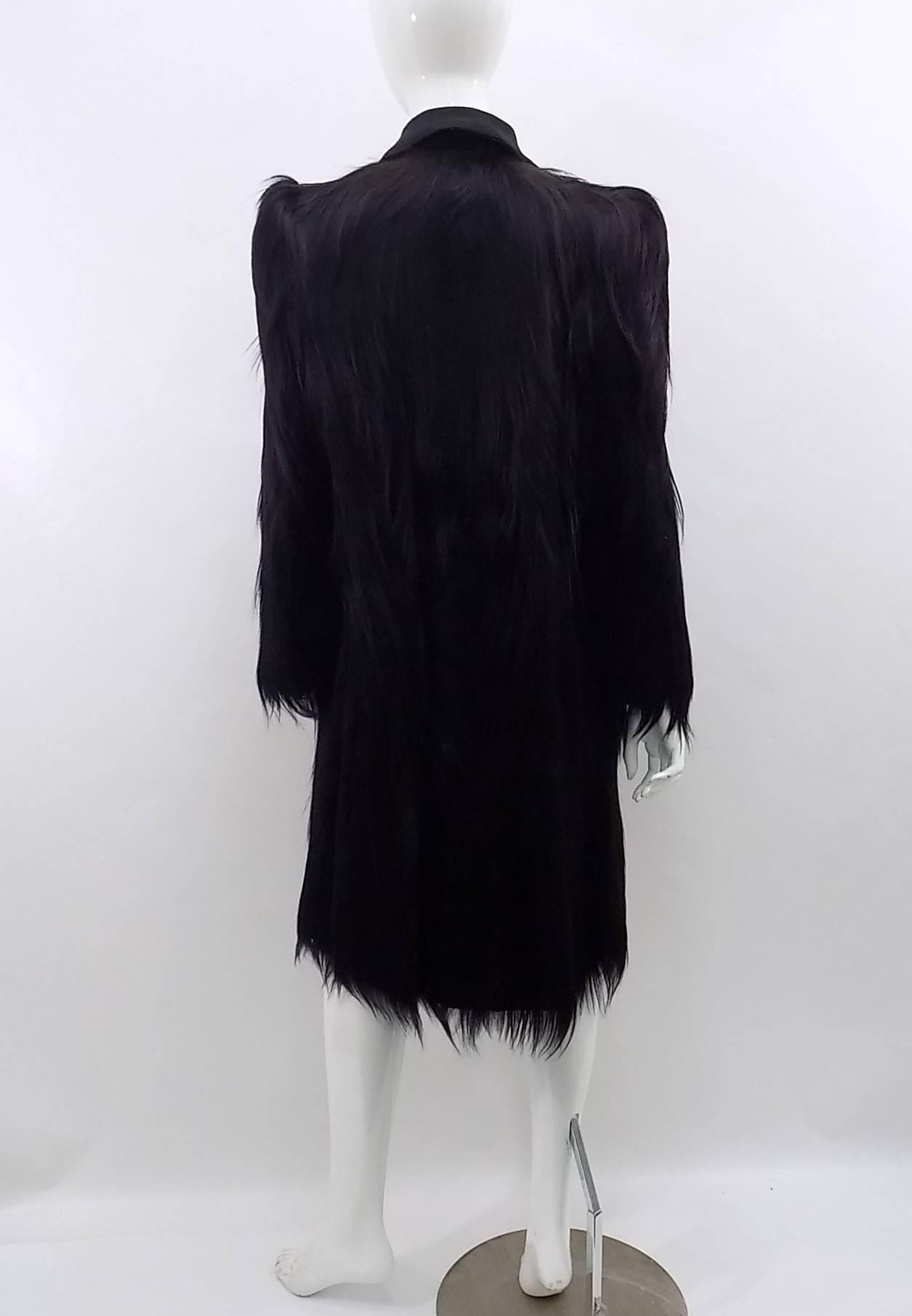 Jet black glossy monkey fur coat in absolutely pristine condition in and out ! Long, shiny Gold Coast monkey fur is plush and thick with no dryness to the pelts. The coat is knee length with a fabric Peter Pan collar and front hook closure. No
