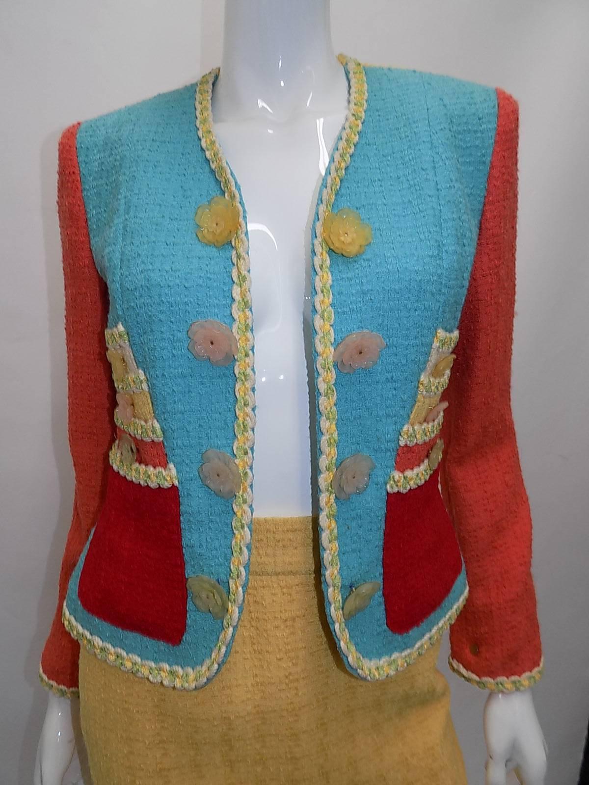 I adore the boucle in contrasting pastel colors; pastel blue, coral, yellow and cream is offset with vibrant red. This  Cheap and Chic jacket features the most adorable cake applique on the front. Frosted floral buttons at the front and at the each