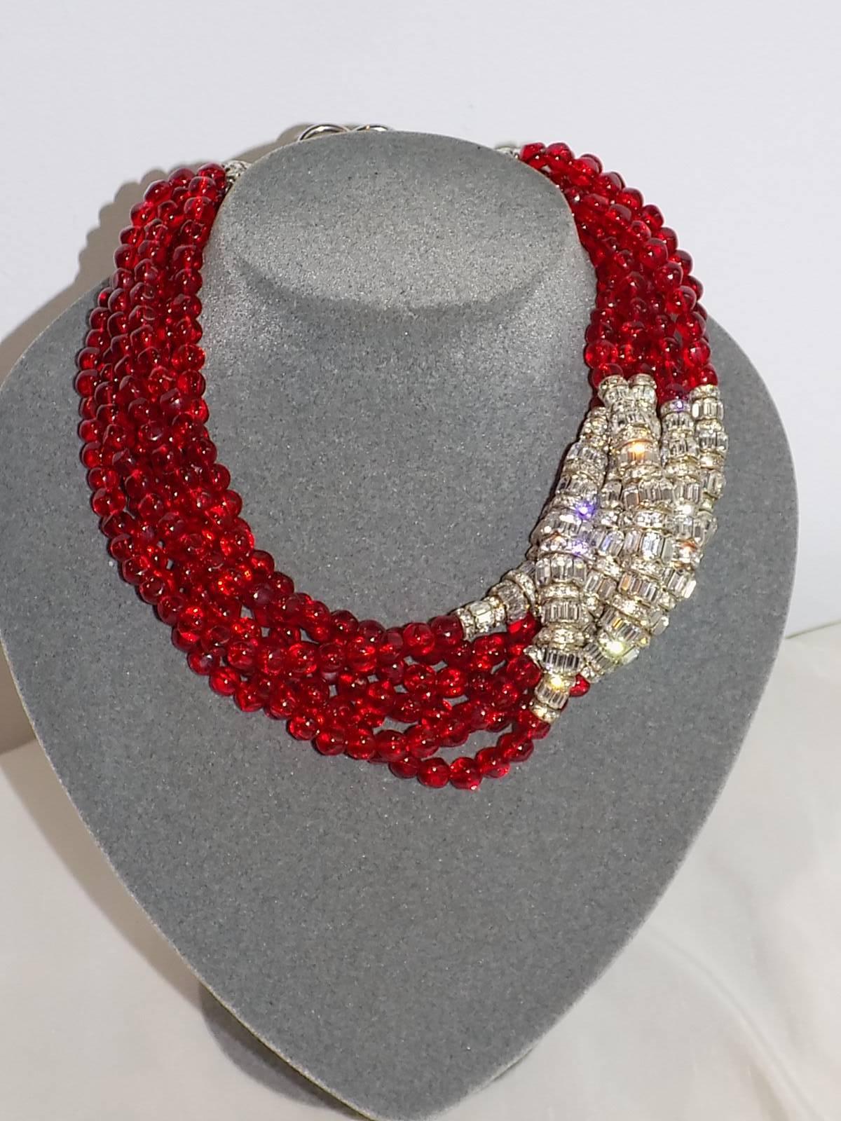 Since 1968 Anne Klein worked for Hattie Carnegie before she started her own company in 1968. When she died in 1974, Donna Karan and Louis Dell'Olio continued designing jewelry for her company. 
You are looking at divine massive   7 rows ruby   red