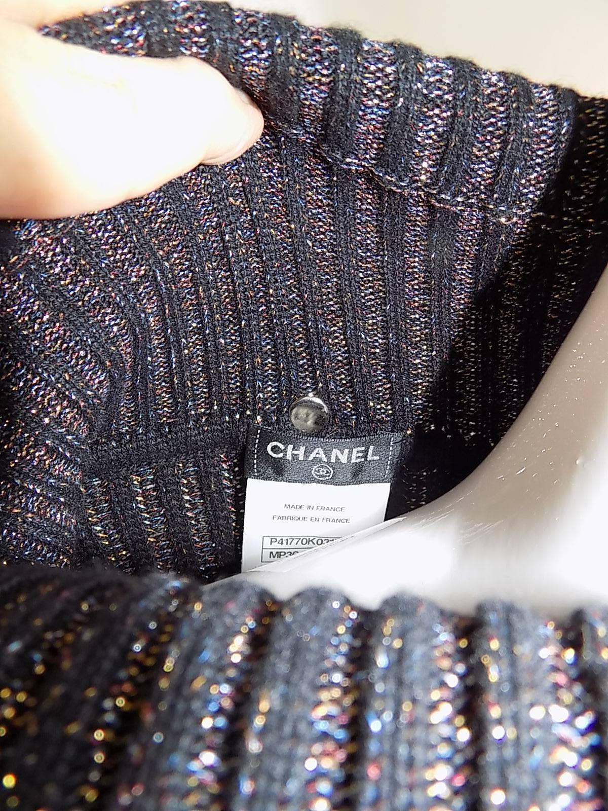 Great pull on Chanel   sweater dress. Black cashmere and  silk blend with touch of silver and gold lurex thread. Turtle neck . Small CC plaque at the bottom. Very soft and comfortable. Size 48. 
Flat measurements
Bust 40