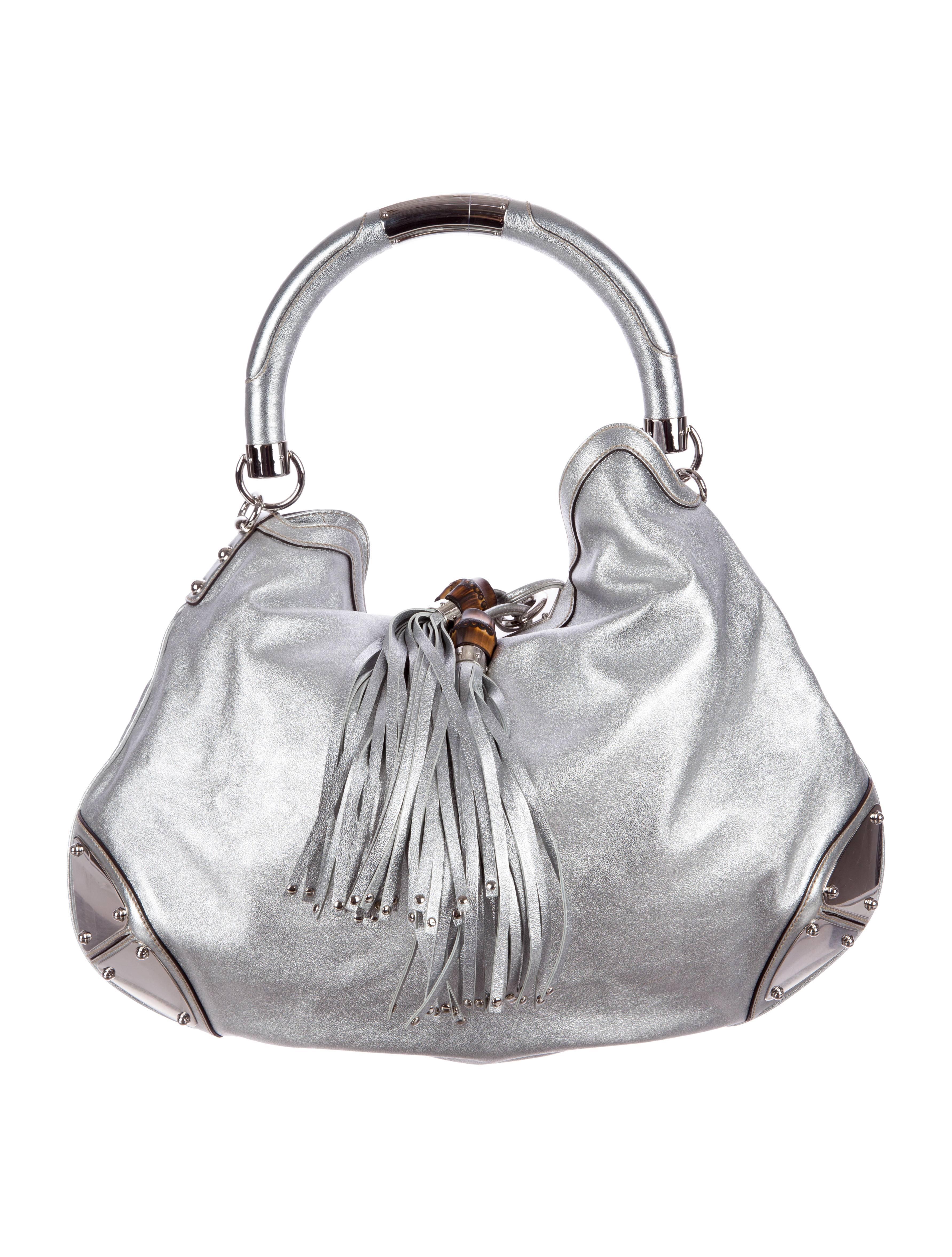 
    Chic, sophisticated hobo-style bag is ideal for everyday use
    Gucci 'Indy' large  hobo bag is made of stunning silver tone leather and adorned with oversize tassels
    
    Silvertone metal studded plates
    Leather piping
    
   