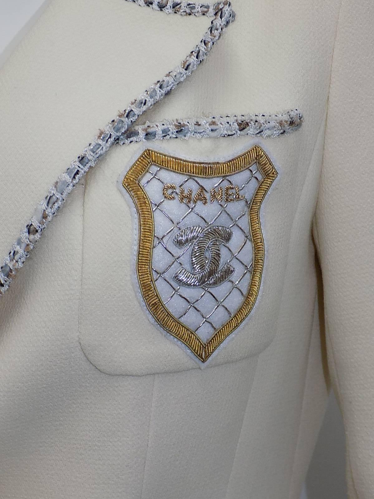  beautiful and perfect for all seasons .Chanel cropped jacket in ivory wool .gabardine  .Thin trim  with a dash of silver and gold thread to compliment silver and gold   CC logo pocket patch . YOU CAN WEAR SILVER OR GOLD JEWELRY WITH  THE JACKET two