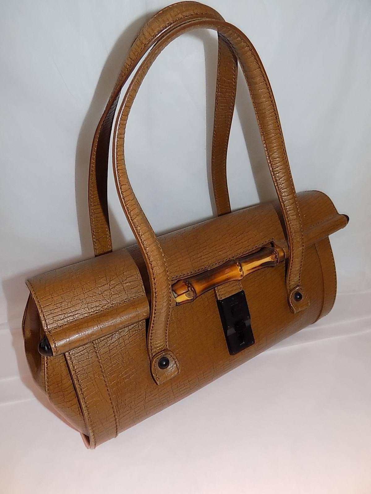 Brown distressed leather Gucci Bamboo Bullet Bag with dual shoulder straps, bamboo detail at front, brown leather interior lining, single zip pocket at interior wall and push-lock closure at front flap. Pristine Condition .
 Measurements: Shoulder