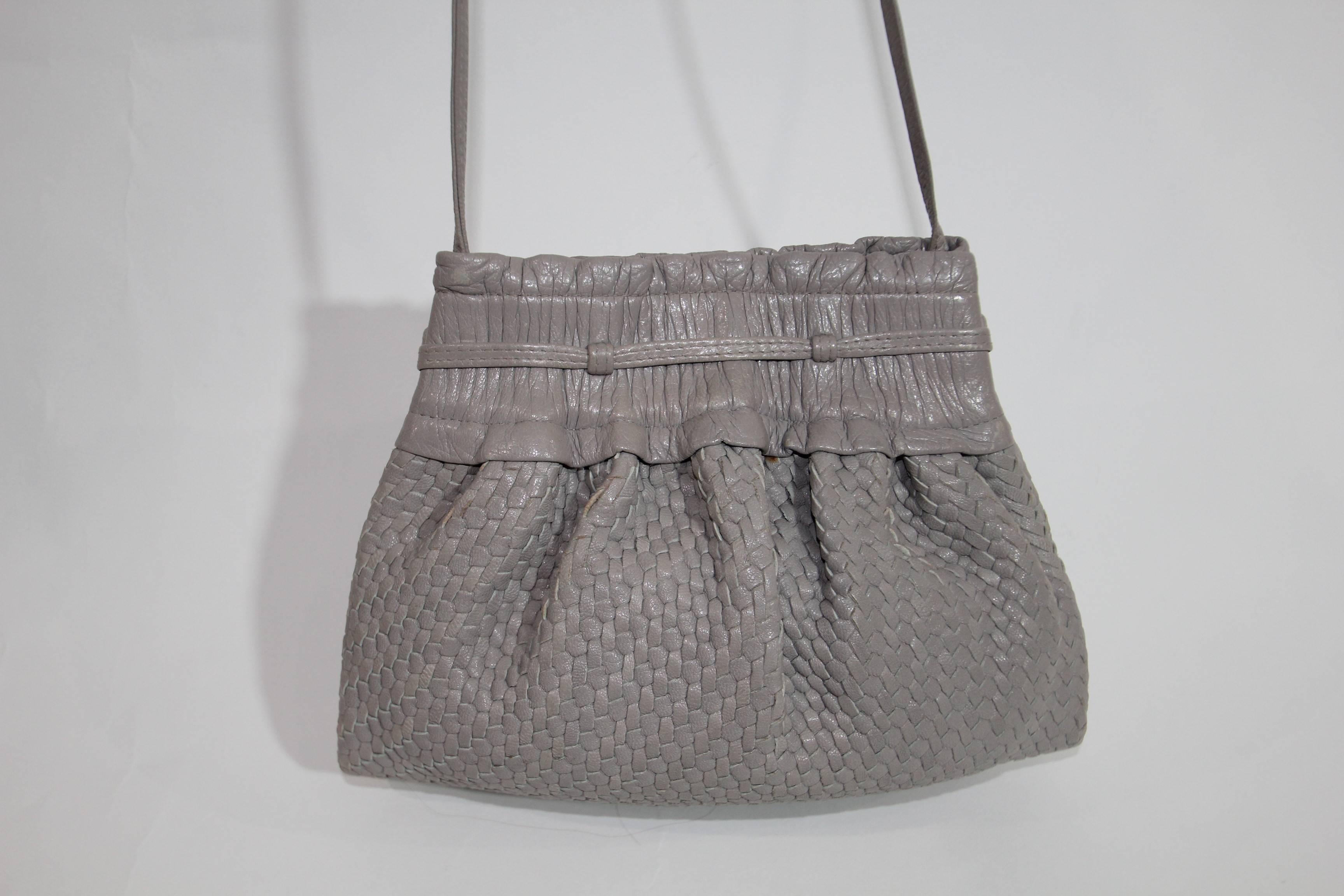 Perfect every day or for the night on the town Fendi Vintage woven cross body  leather bag . Light grey color. Snap closure. Fendi insignia lining. One zipper pocket. Excellent condition. Very soft . 
Mesures 10