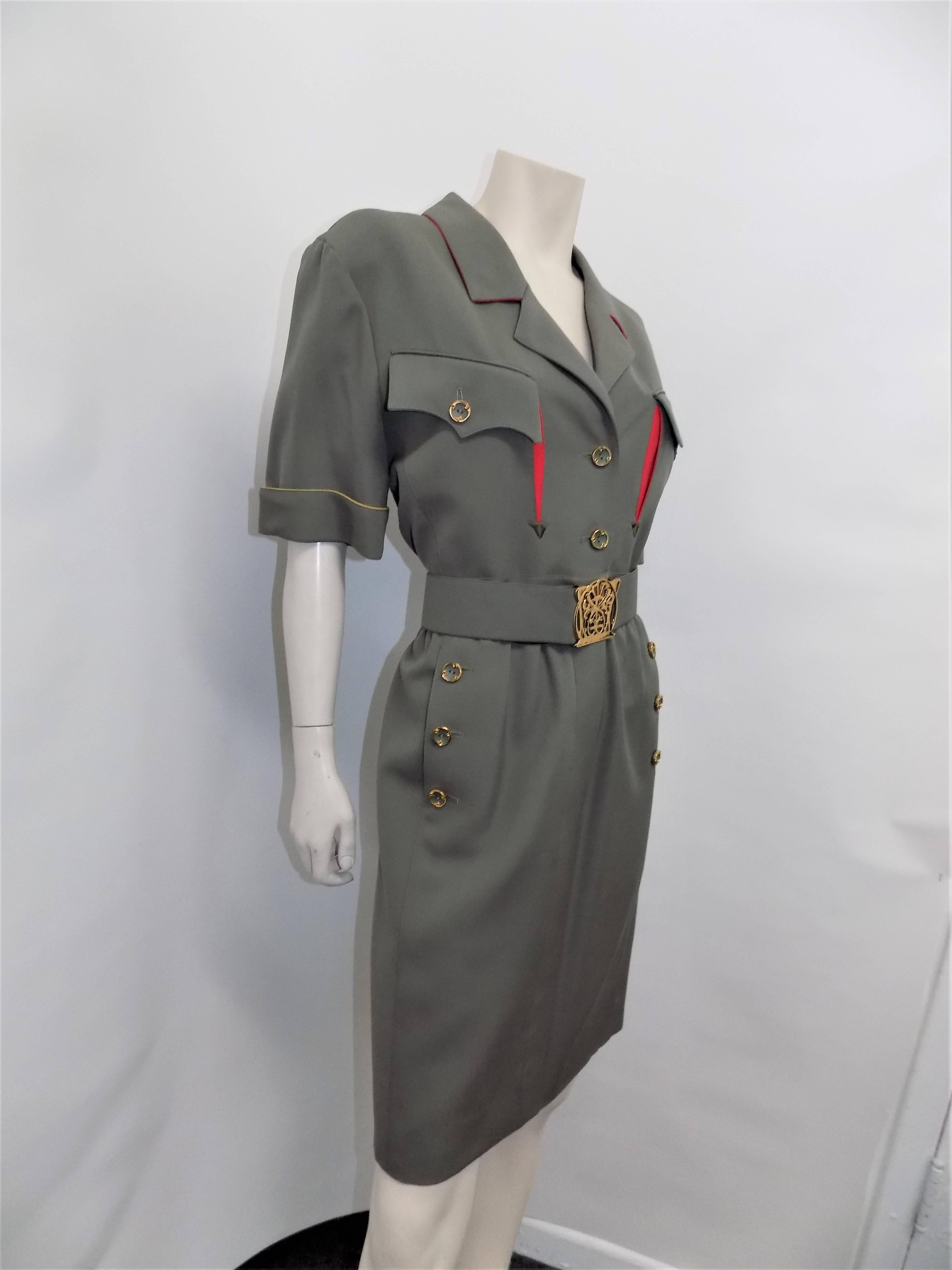Never worn must have spectacular military style vintage Karl Lagerfeld dress. Light  wool gabardine fully lined. Dress feature wide belt with gold tone carved out logo buckle., amazing custom made buttons, and multi color underlined pocket flaps ,