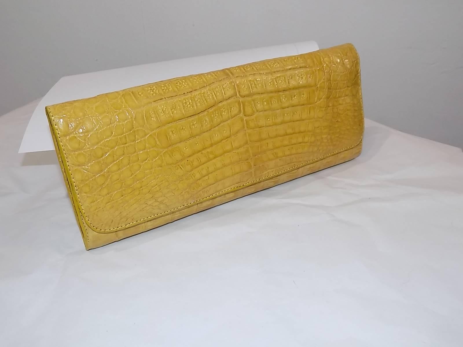 Rinkel is a luxury brand well-known for its sought after accessories elaborated in premium crocodile skins using traditional techniques and high end Italian hardware.This is hardly ever used Alligator  Luxury  evening Clutch Bag  in rich yellow