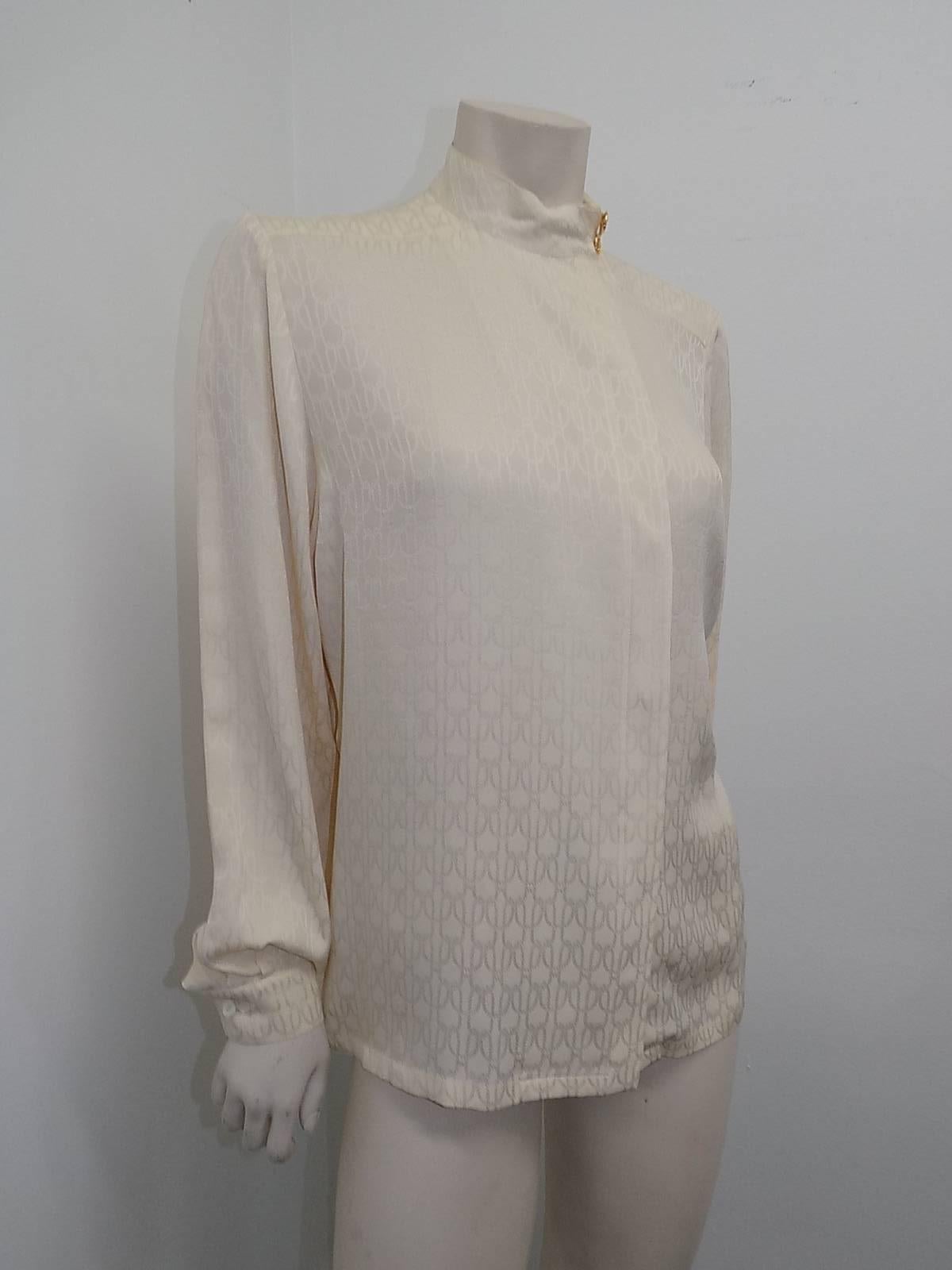 Hermes Truly  Stunning Jacquard silk print creme blouse featuring side concealed button down closure, Russian collar  with two amazing vintage Hermes large buttons . 100% silk  size 42 shoulder 15 1/2" bust 44"
 length 25 "sleeves