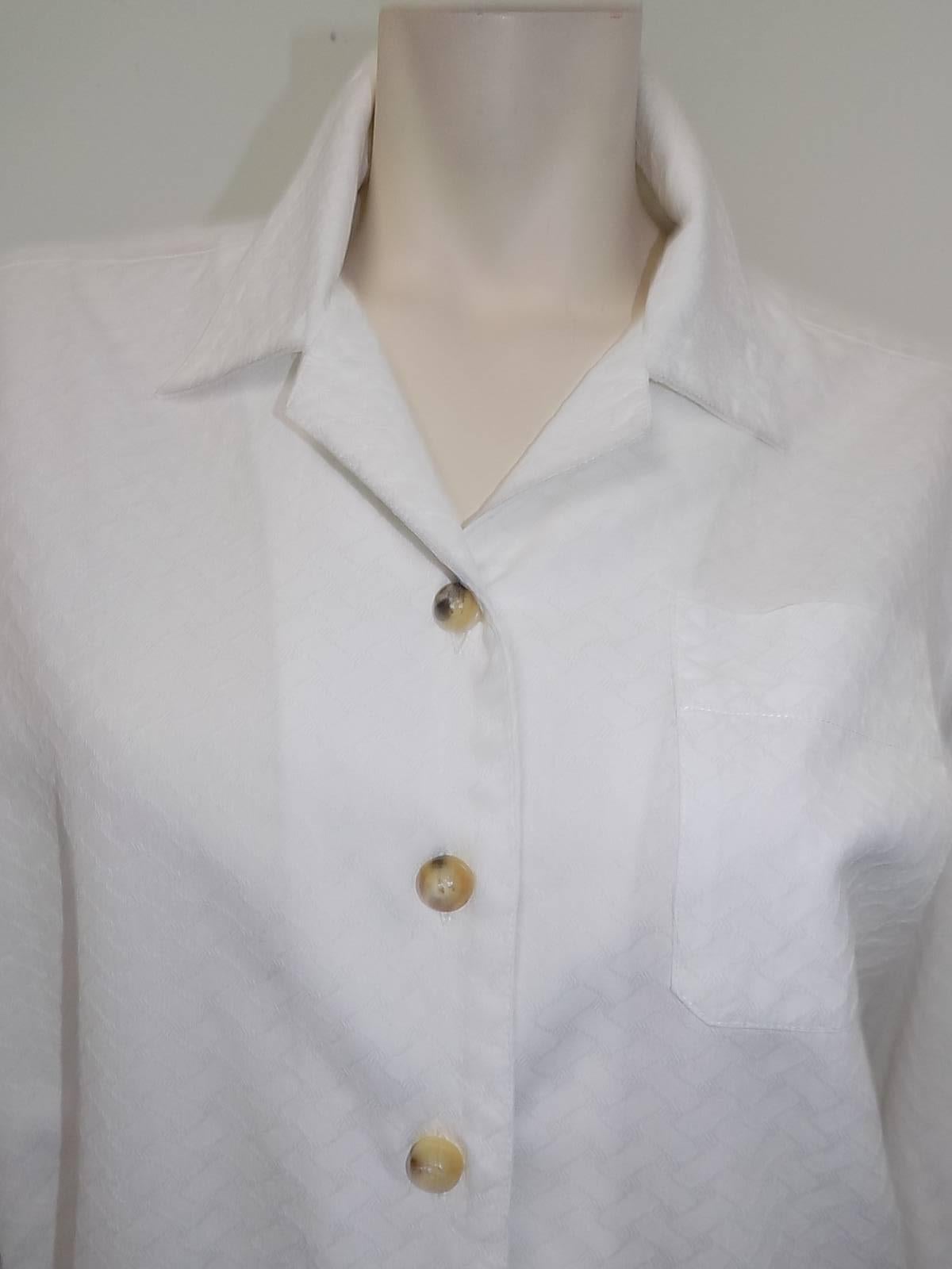  Perfect 100% cotton  crepe Hermes white  shirt . Crisp and fabulous featuring one top pocket, folded  cuffs, collar , back fold and beautiful horn buttons that are engraved " Hermes" Size 42 bust 46" length 27" sleeves 23" 