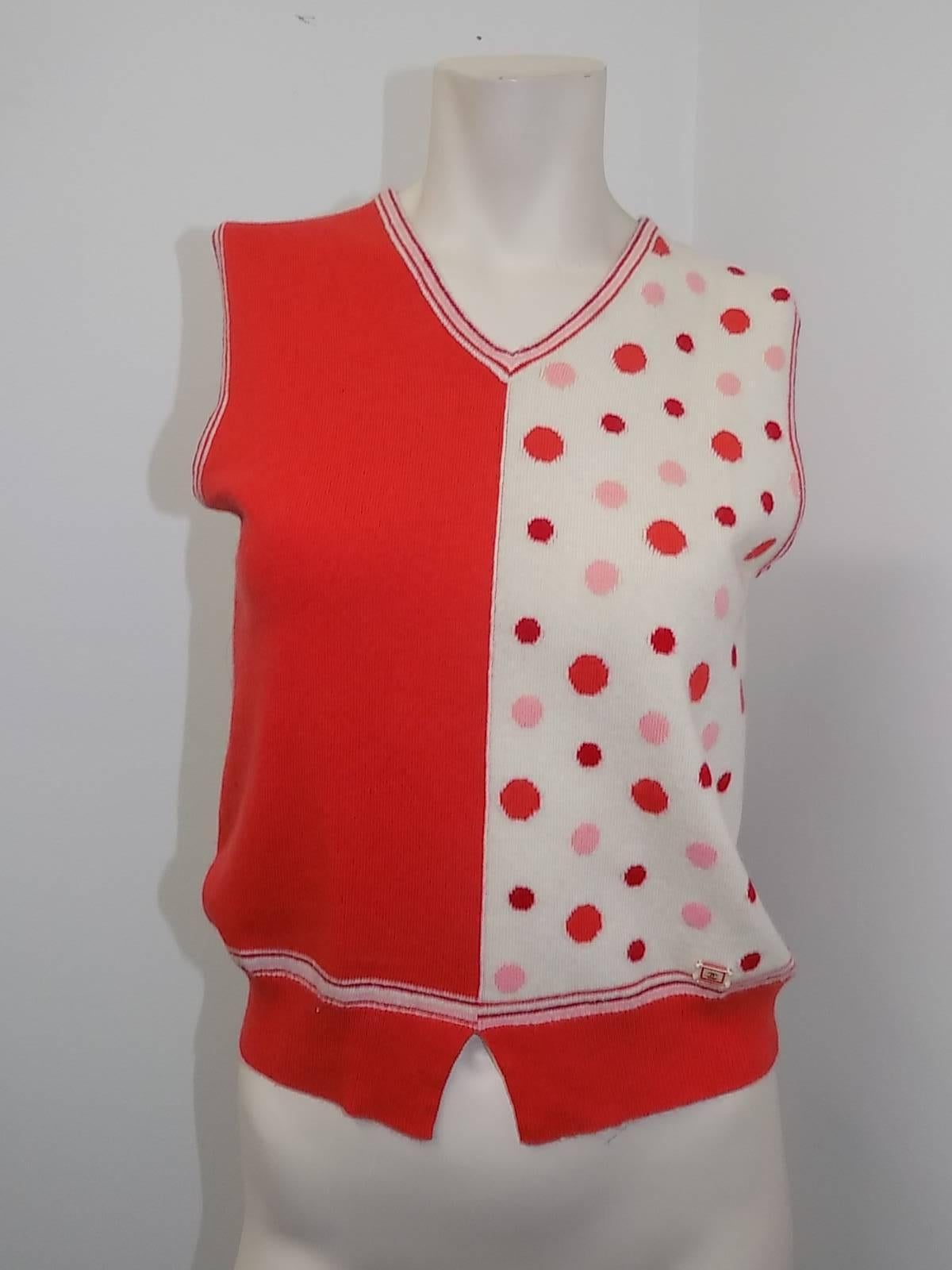  Fabulous and in pristine condition Chanel  two colors  red and orange 3 piece 100%  cashmere sweater. It has two different sleeveless tops,one with polka dots and one solid.  Set features white bread trim detail and clear cc logo buttons. French  