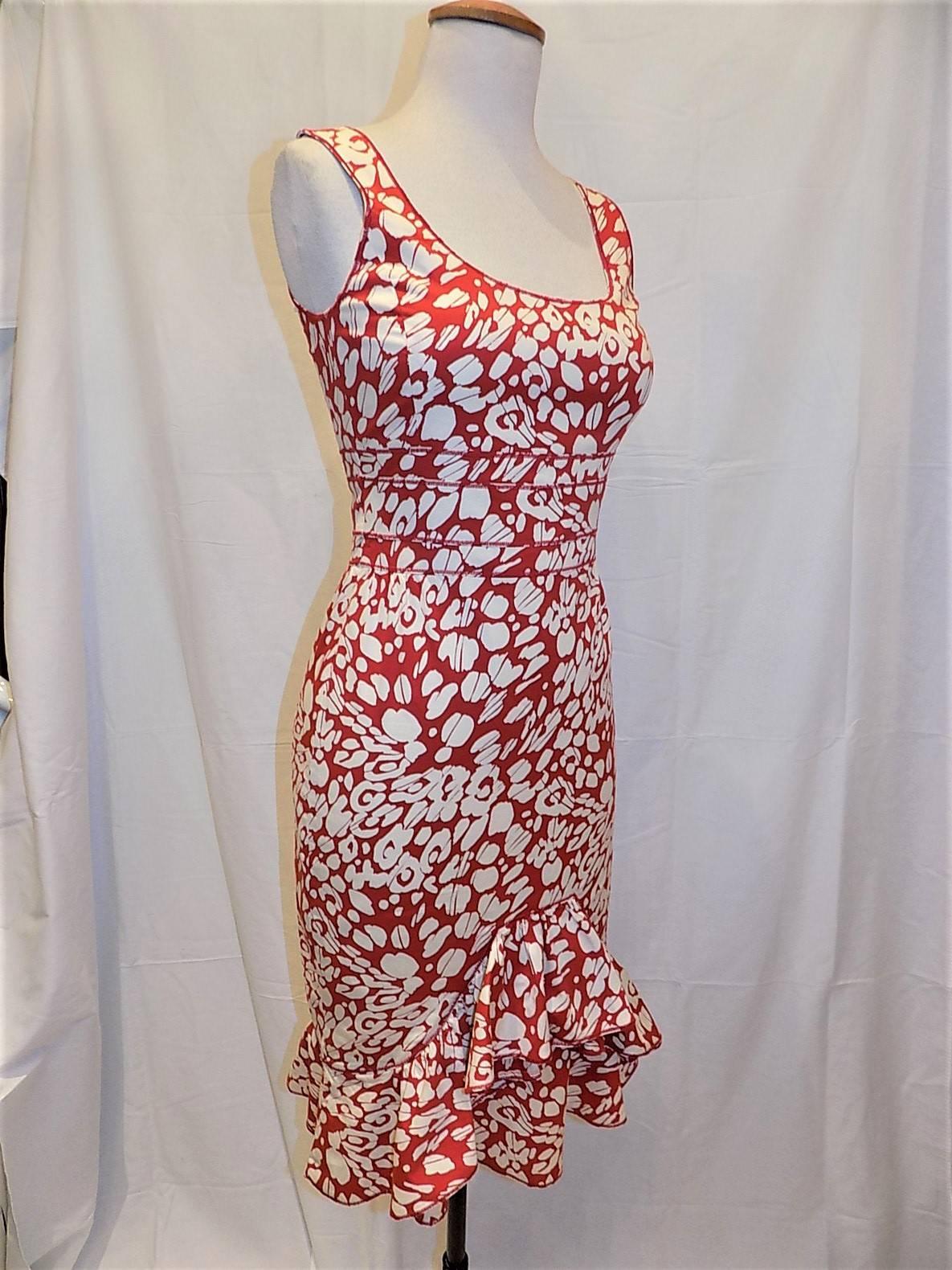 Representing his hispanic  backgound this fabulous red and white summer cotton dress is a must in your closet . Very feminine and sexy. Round neckline with hourglass silhuette . Front ruffle