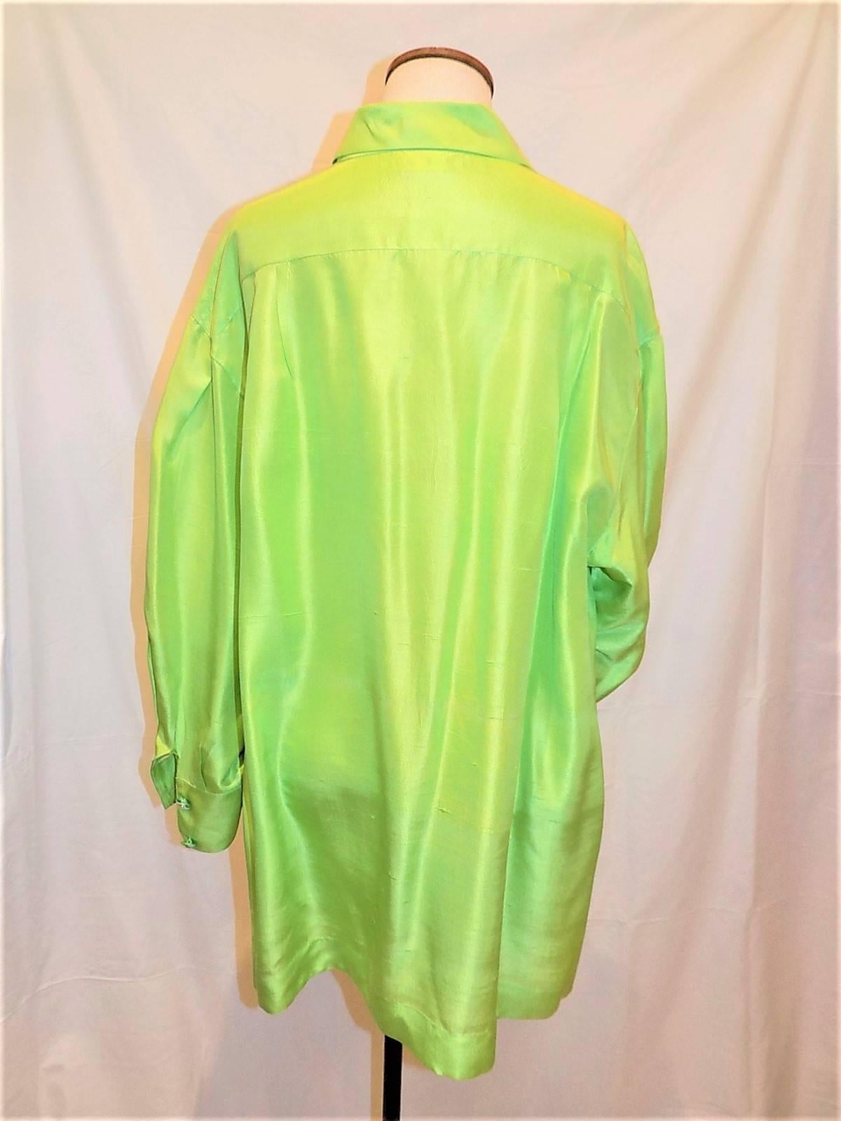 Silk vintage Chanel lime green silk blouse top tunic. Side slits. Front button down closure with  green and white carved cc logo buttons. Excellent contion. 
Bust 44 
