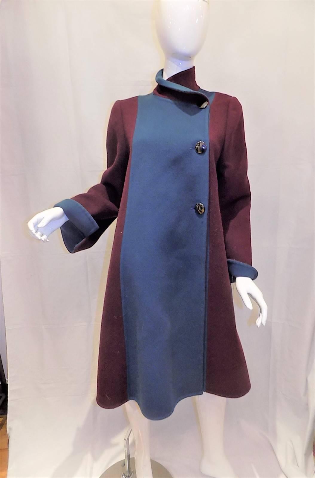 So elegant , perfectly structured. beautifully tailored winter coat by Pauline Trigere. In pristine condition like new. Two tone , side closure with large buttons and high collar. Medium heavy boiled wool. 
Bust 40" sleeves 25" length