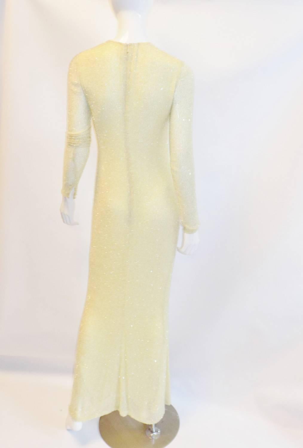 Pale yellow silk chiffon with clear beading makes this dress truly spectacular piece of art, very rare to find such a simple design yet so elegant and eye catching. The dress is entirely hand beaded and in fantastic condition. Very clean without