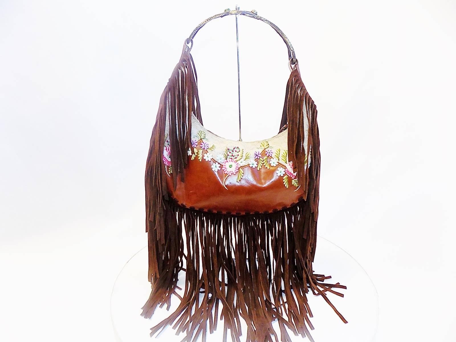 Beautiful brown leather with lace and hand ribboned embroidery adorned with beads. Serpent handle with jade stones. Long suede fringes. Very rare bag, there is a few black suede on the market, but not like this one. Pristine condition. 
Height:
