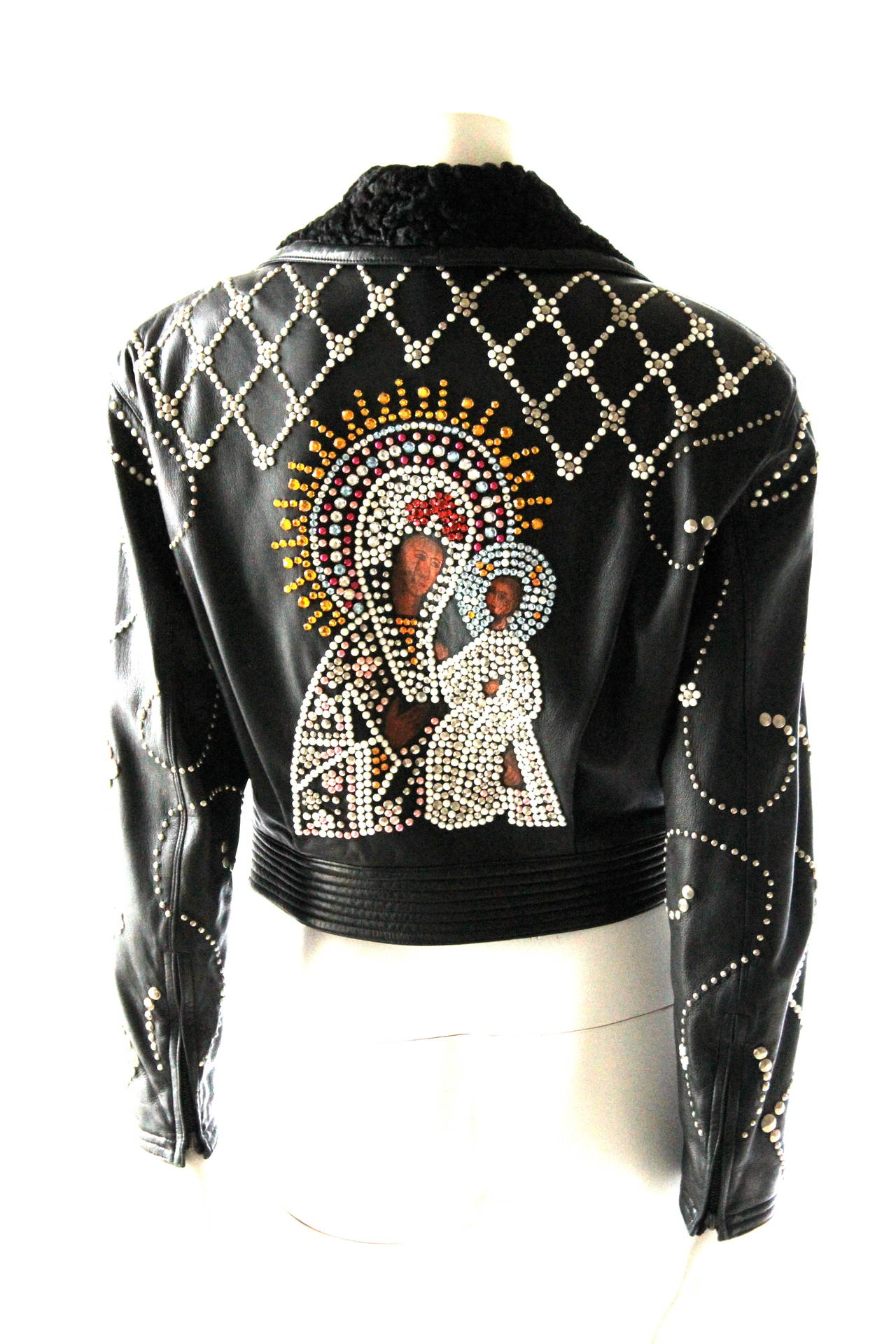 Iconic Gianni Versace Jewelled Madonna and Child Leather Runway Jacket

Couture Collection 1991

Hand Painted details for Madonna and Child
Very soft and subtle leather with fur collar

approx size 40