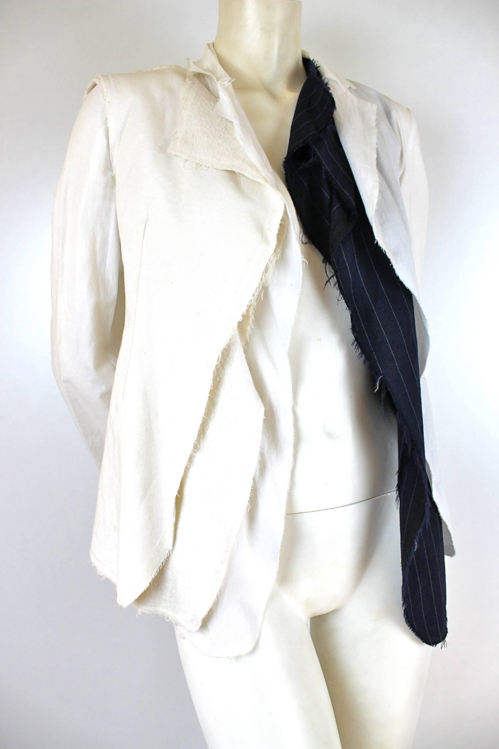 Comme des Garcons Ad 2002 Runway Jacket
Very unusual construction even for CDG
White cotton jacket with wool pinstripe suiting and exposed interfacing 
Labelled size M