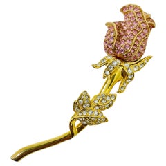 Spilla vintage firmata NOLAN MILLER con motivo floreale a rose, in tonalità dorata e con cristalli incastonati a pavé
