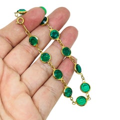 Pulsera de diseño vintage de SWAROVSKI con el cisne de la marca, chapada en oro y con cristales esmeralda