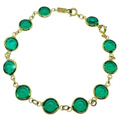 Pulsera de diseño vintage de SWAROVSKI con el cisne de la marca, chapada en oro y con cristales esmeralda