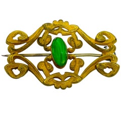 Antique 1920s gold tone filigree ornate oval green glass cabochon brooch