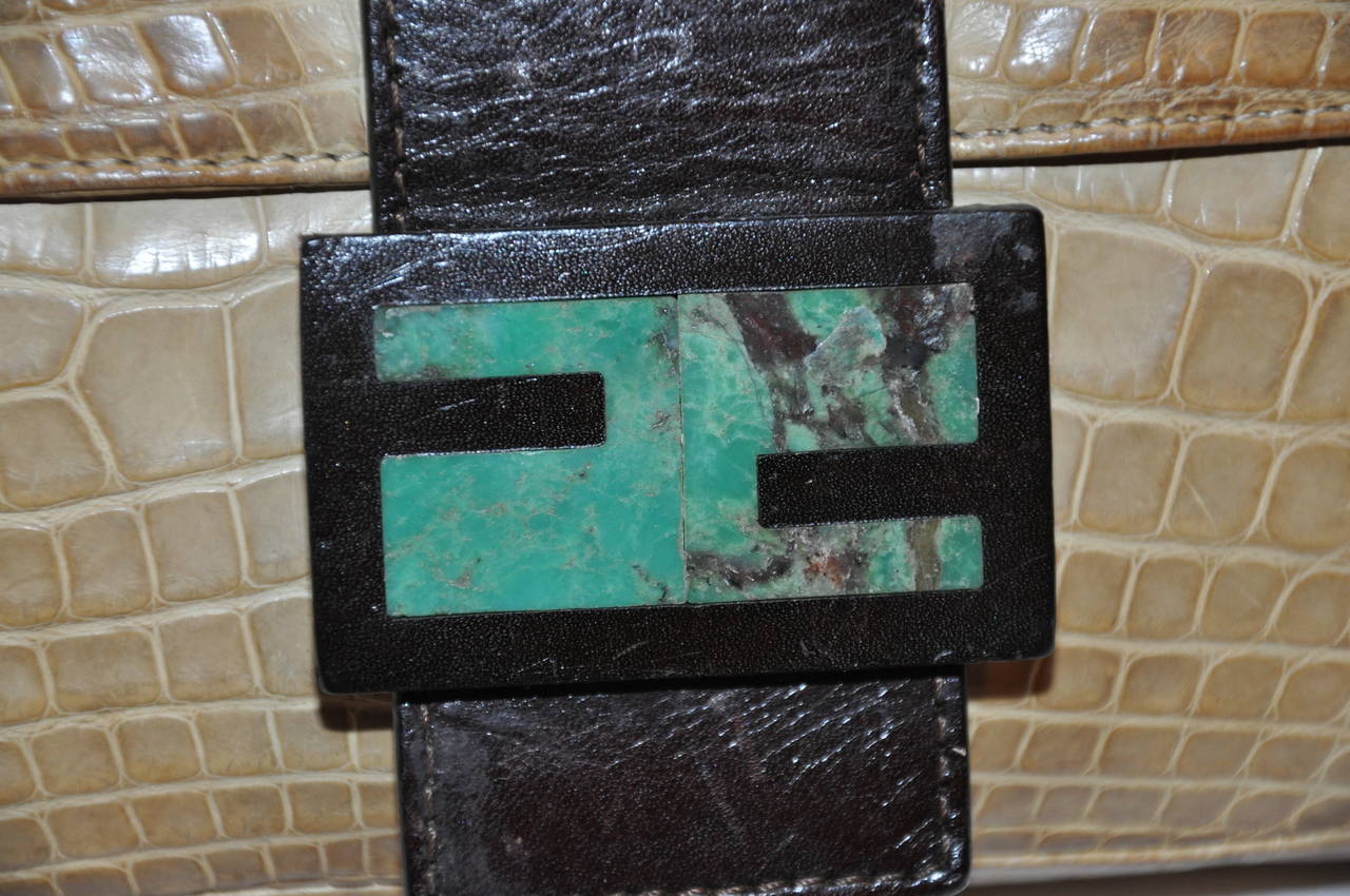 Fendi baguette croc-embossed with malachite accent on the front flap. The cream-color bag is combined with dark-brown flap with the center malachite stone.
   The length measures 10