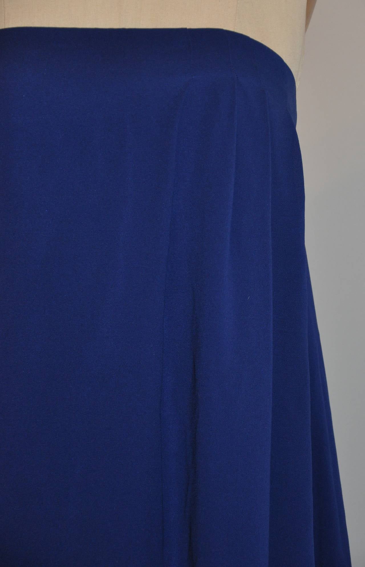This wonderfully elegant Jil Sander strapless cocktail dress in bold blue is enforced with an interior black elestaic band with hook and eye to help with the fit and appearance of this wonderful dress. The length ranges from 36 1/2