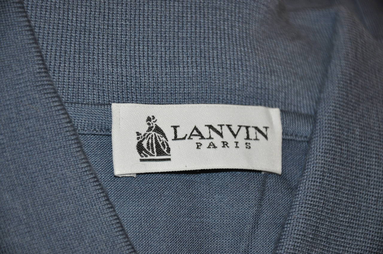 Lanvin men's blue superfine merino wool has a three-button front accented with a breast pocket. The interior of the pullover comes with an extra button just in case. Size is medium/Italy.
   The shoulders measures 20