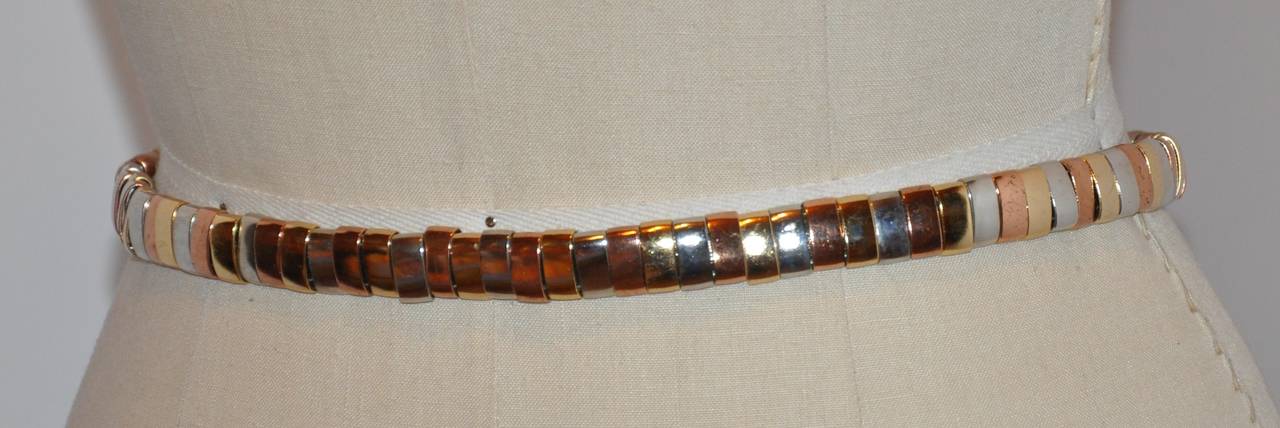 Morris Moskowitz gold, rose and silver hardware link chain belt is accented with calfskin leather. The belt measures 1/2