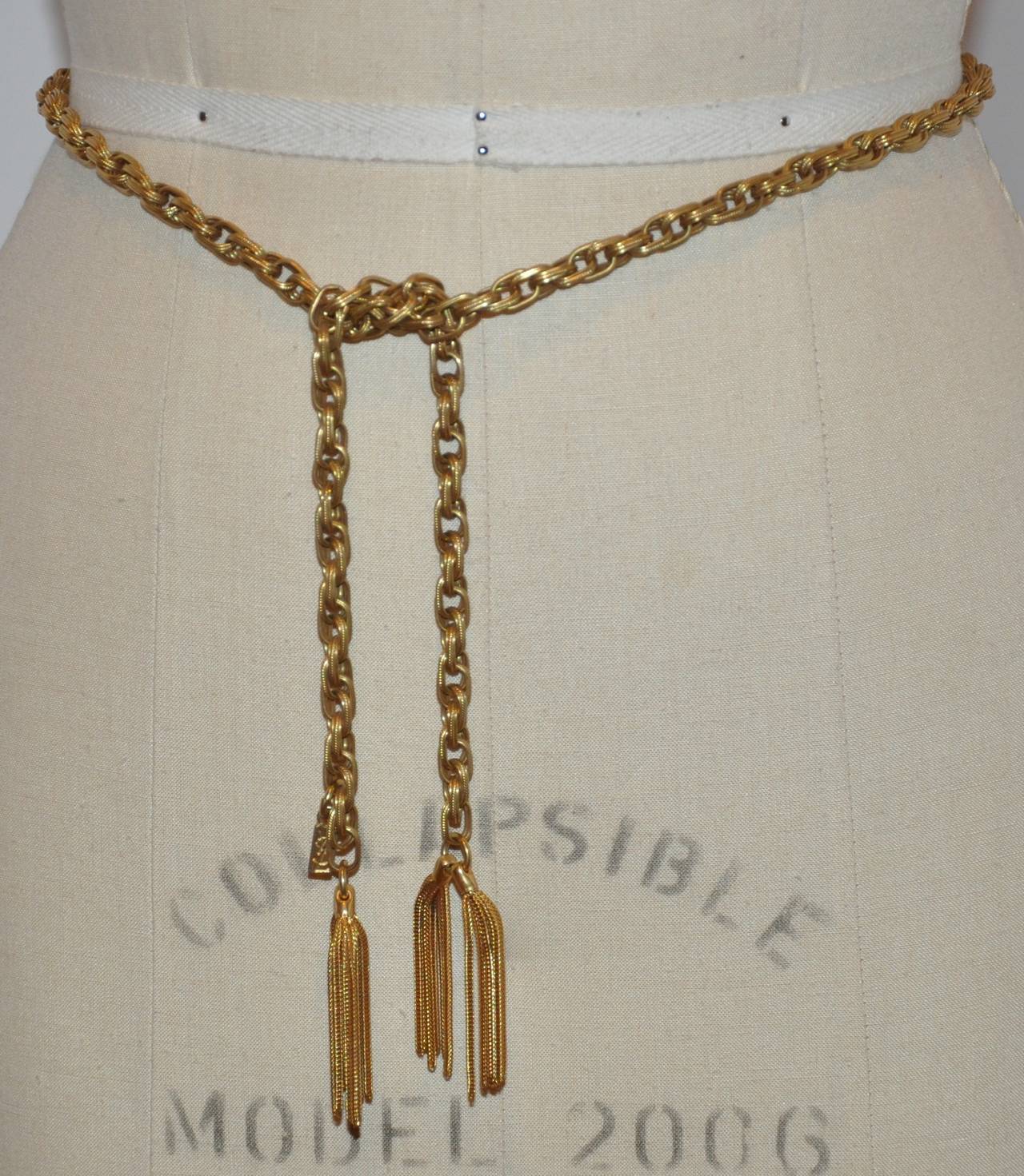 Yves Saint Laurent signature gold hardware link chain belt is accented with 2
