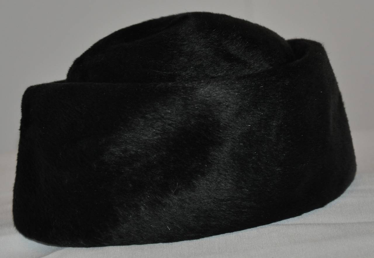 Christian Dior wonderfully elegant black brushed felted wool "Brigitte" tall hat measures 6" in height. The circumference measures 22". The exterior band measures 4" in height.