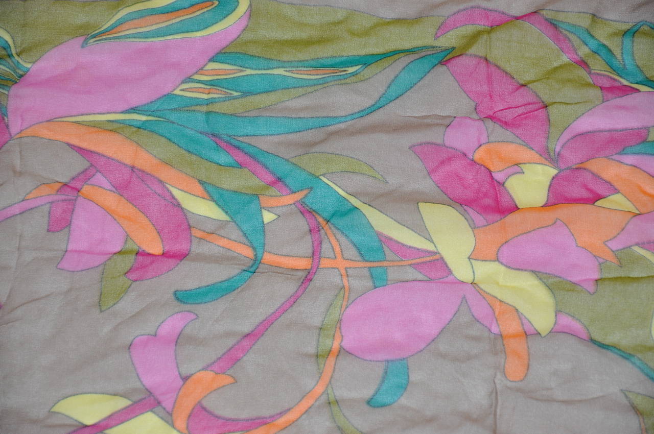 Bold multi-color floral silk chiffon with hand-rolled edge scarf measures 16" x 44". Hand-rolled edges are in cream.