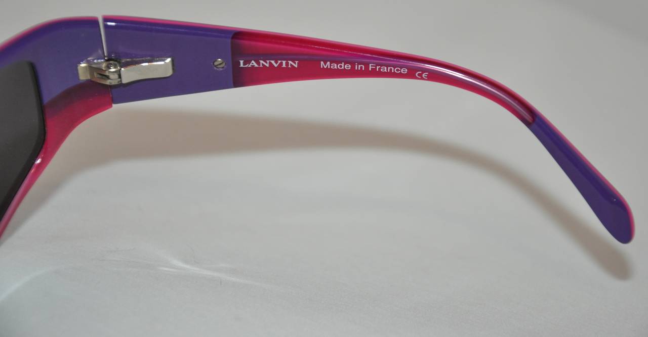 This wonderfully Lanvin Black lucite sunglasses is accented with bold purple and fuchsia interior, along with silver hardware detailing.
   The front measures 5 1/2