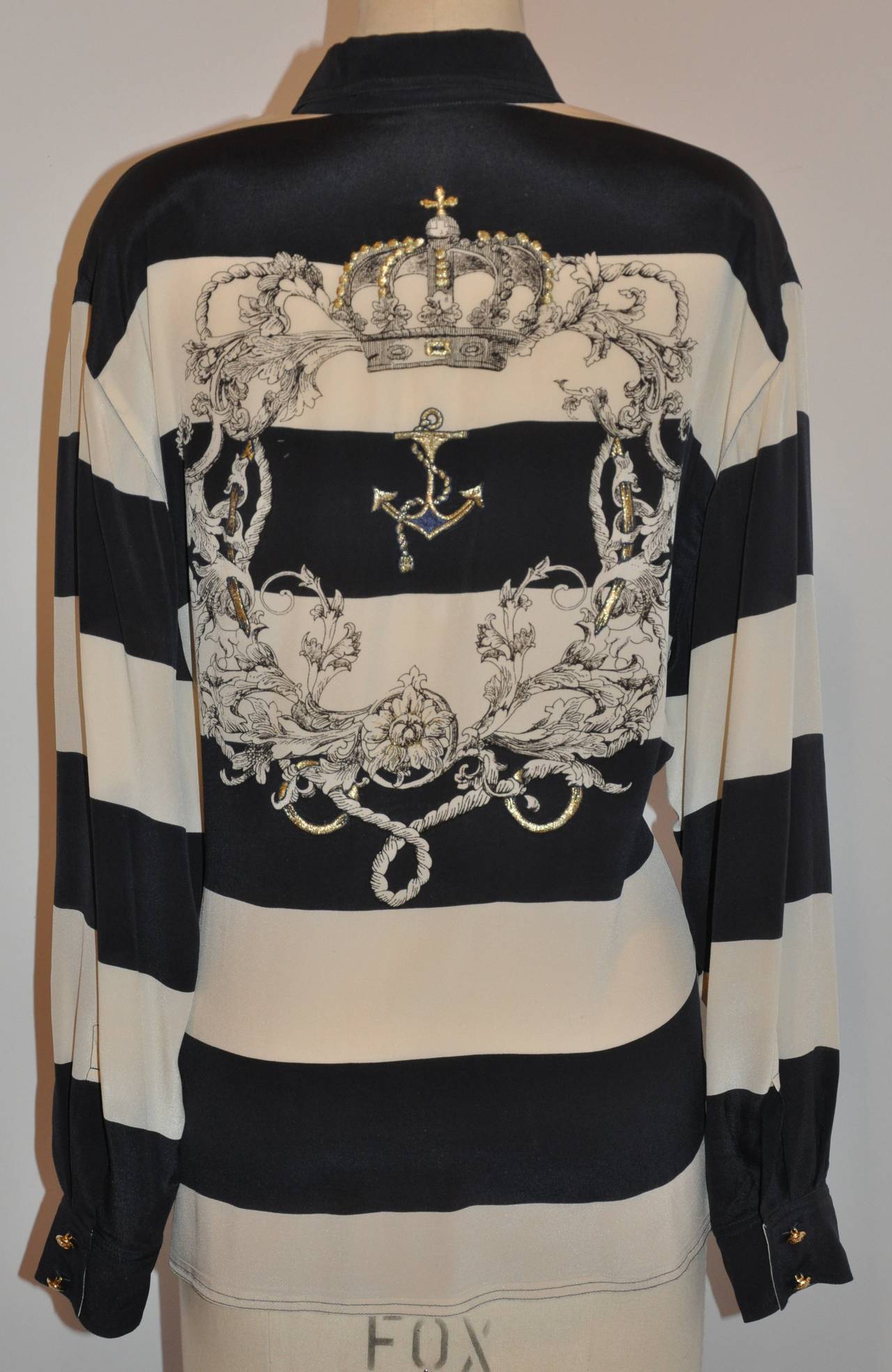 Dino Valiano navy and cream silk blouse is accented with metallic gold lame embroidered on the collar and within the print on back.
   Made in Germany, size 42, the shoulder measures 19 1/2