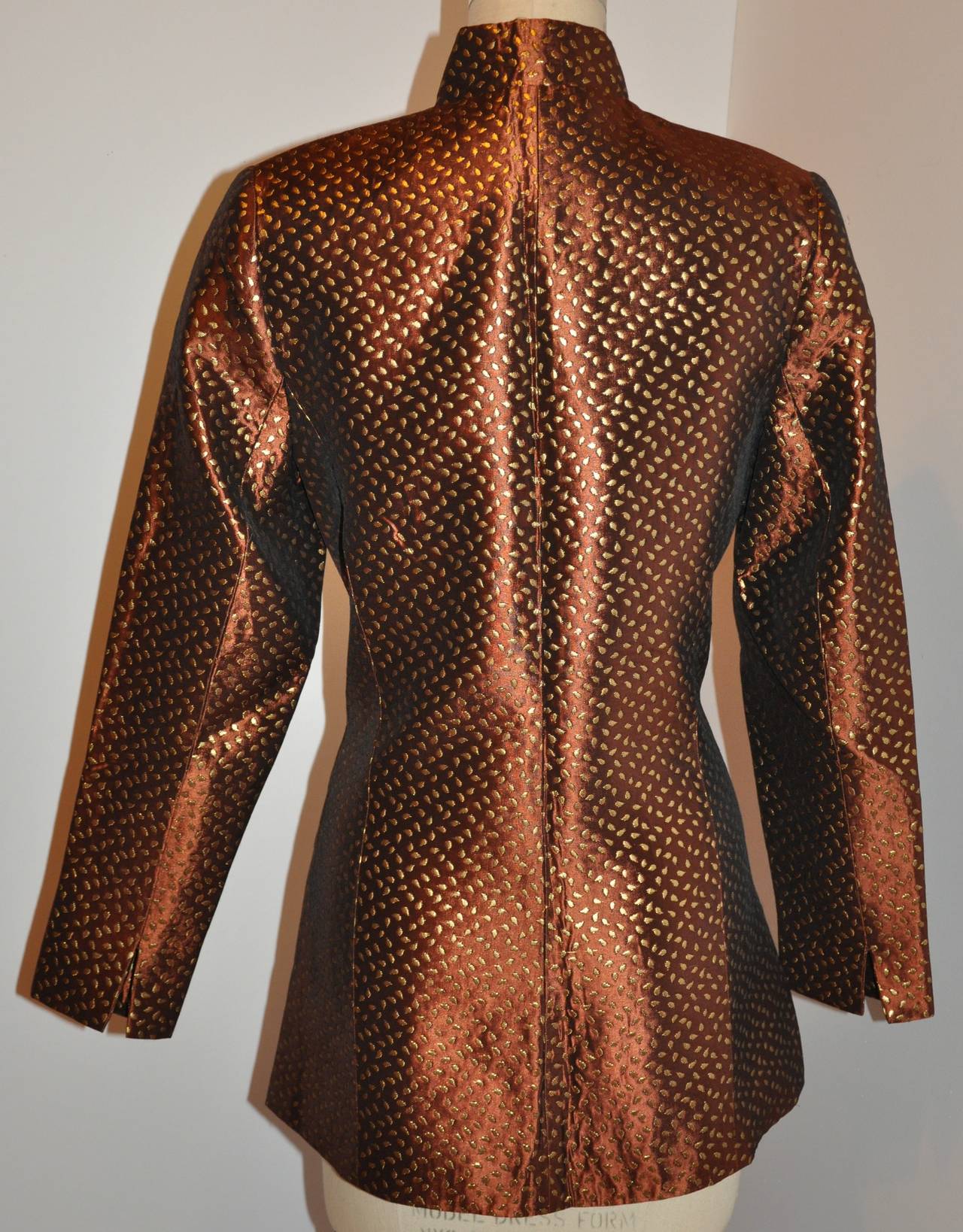 Mirabelle wonderfully detailed fully lined with bronze silk button jacket is accented with slits on the sides of the jacket and also on the sleeve's cuff. 
   The jacket is fully lined with matching bronze silk. There are ten gold hardware engraved