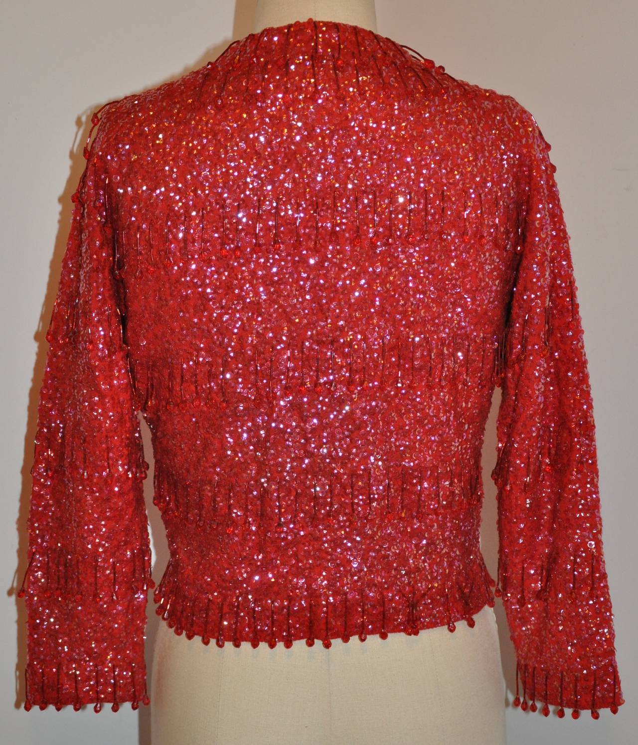 This wonderfully ruby-red angora cardigan is hand-beaded with micro sequins and micro glass seed beading throughout.
   The shoulder measures 15 1/2