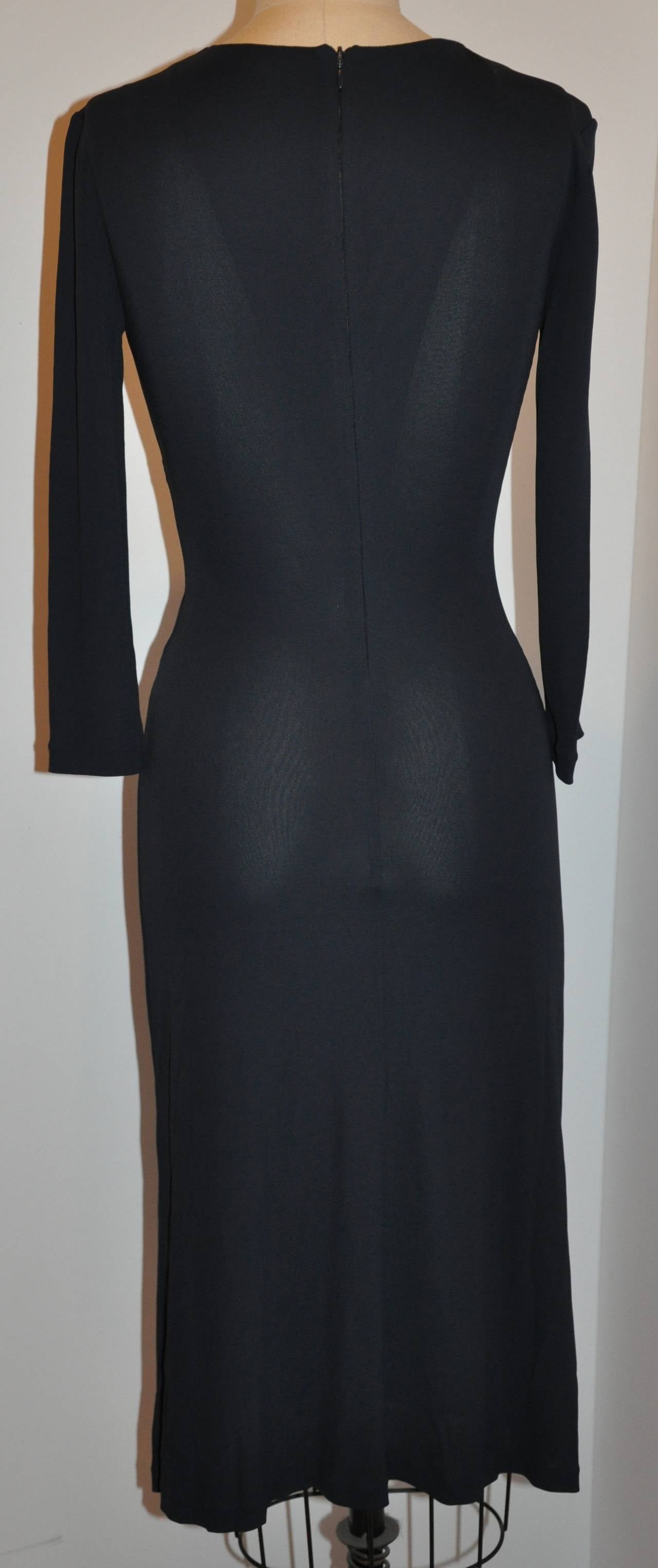 Georgio Armani midnight blue silk jersey form-fitting dress has a wonderfully elegant, yet sexy and flattering deep-plunge front. The sleeves are mid-length, just enough to cover the elbows.The invisible center back zipper measures 16