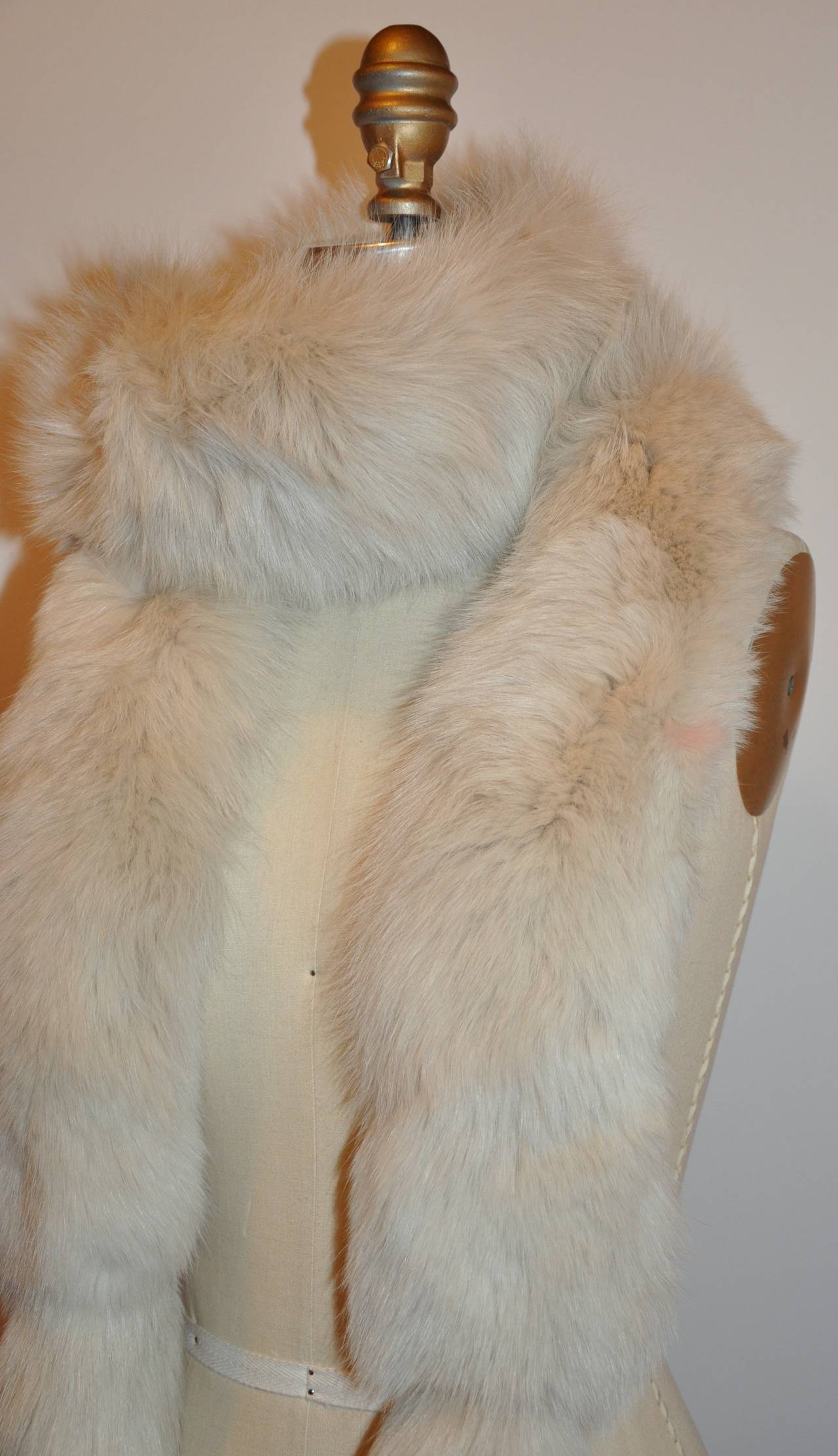This wonderfully elegant Maxiamlian warm cream fox fur from female skin is accented with fox tails on both ends of this elegant and timeless scarf. The scarf measures 82