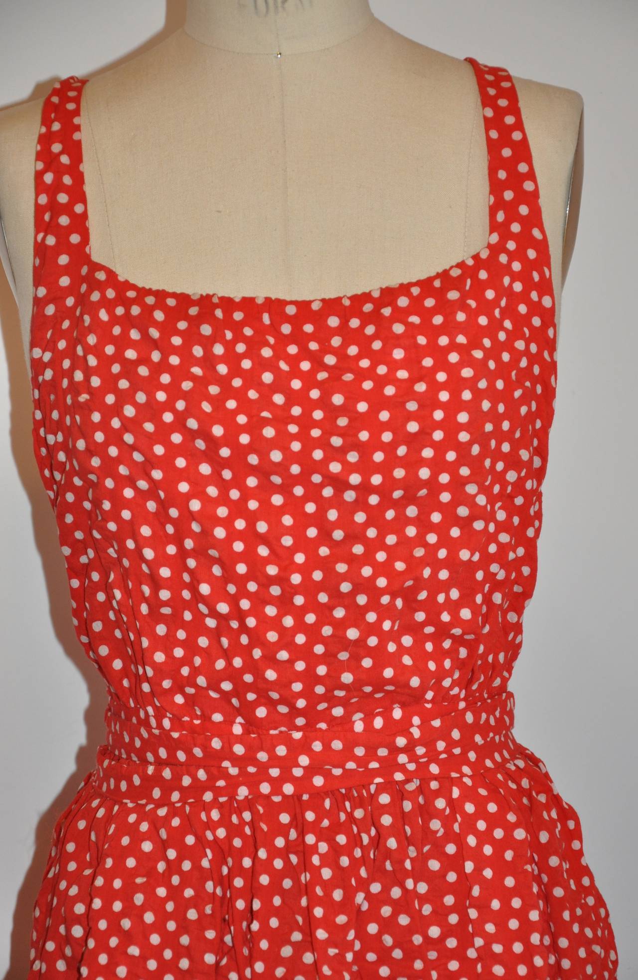 Halston's wonderfully bold red polka-dot halter dress made of sheersucker cotton is simply perfect for those warm summer days. The sheersucker cotton dries in literally seconds, so you would be cool in those hot summer days.
   The back has a