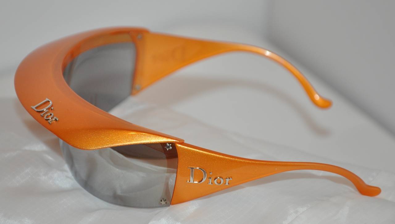Christian Dior's wonderfully wicked tangerine wrap around sunglasses has an optional tangerine detachable brim if desired to shielded from the bright sun during any outdoor activities for extra protection. Just gently slid near the front corners.