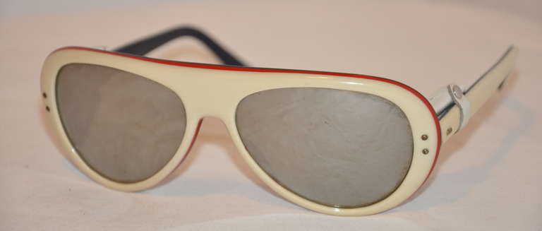 This wonderfuly detailed Martin mirrored sunglasses are ivory tone lined with red along the rims. The interior is finished with black lucite. The interior from corners has lambskin ivory leather for added sun protection. silver hardware accents