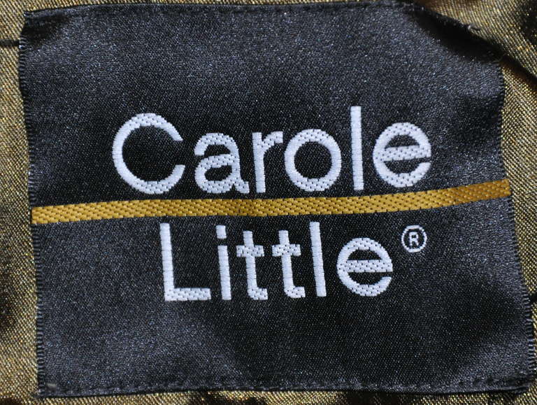 This wonderful Carole Little car coat in forest green sheared beaver is light-weight with two (2) set-in pockets in front. Shoulders are slighly padded along with slightly-shaped domain sleeves tapered at the cuffs. The front has four(4) hidden
