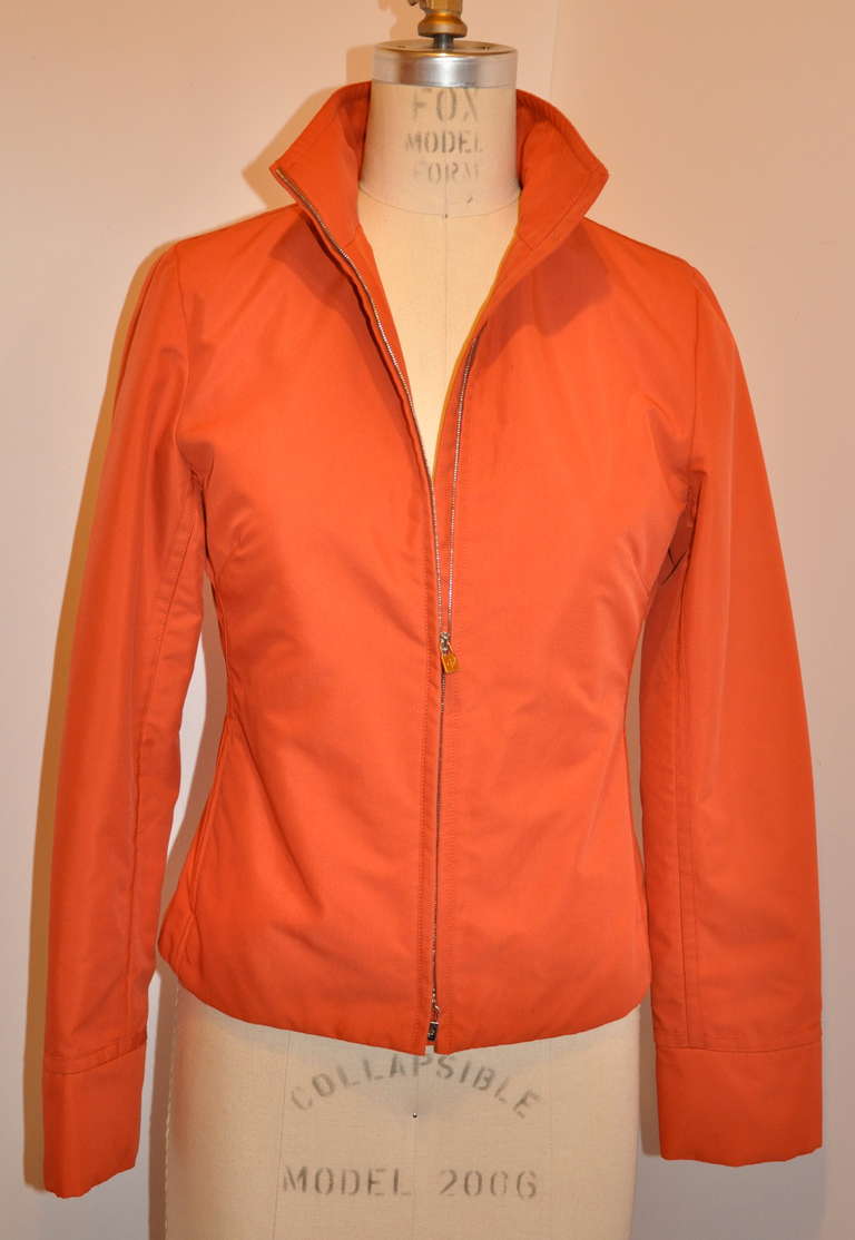 Loro Piana brick-orange zippered jacket has a two-way zippered, so one can unzip the bottom while keeping the top halp zippered if desired.
   Fully lined with 60% viscose, 40% cotton. The exterior is 97% esterno, 3% polyester.
   The front